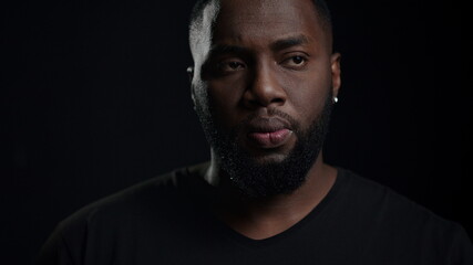 African american man getting an idea indoors. Dreamy man posing in studio