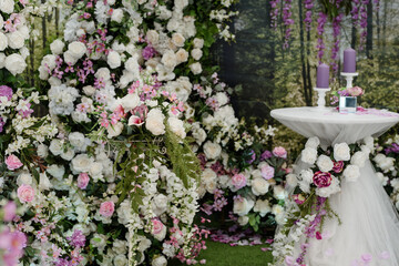 Wedding ceremony Photo booth zone decorated with roses and candle composition.