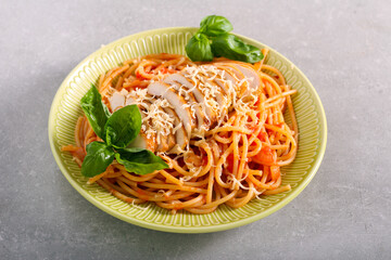 Spaghetti with tomato sauce chicken fillet on top
