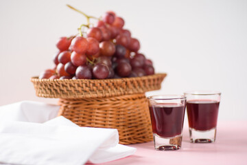Red grape juice in glass with grape fruit	