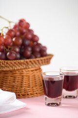 Red grape juice in glass with grape fruit	