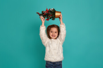 Merry Christmas and happy holidays. Cute little baby girl holding a Christmas tree. Christmas holiday concept.
