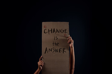 Change, Protest , Mob or Expression Concept. Person Raised a Corrugated Paper in the Dark. Front View
