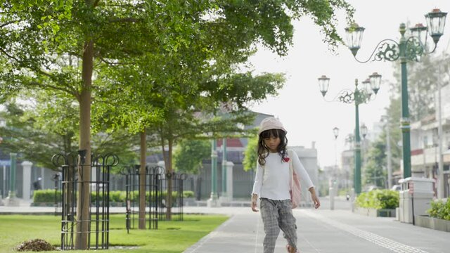 potrait little girl playing alone in the park