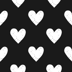 Valentine's Day block print seamless pattern with grunge textured white hearts on black background