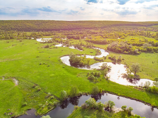 Fototapeta na wymiar aerial drone landscape of river in green field, top view of beautiful nature texture from drone