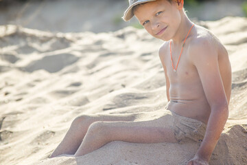 boy playing sand on the beach
