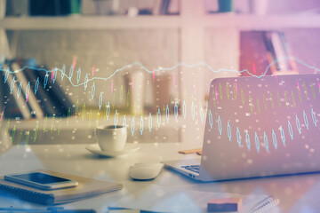 Financial chart drawing and table with computer on background. Double exposure. Concept of international markets.