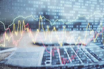 Financial graph colorful drawing and table with computer on background. Double exposure. Concept of international markets.