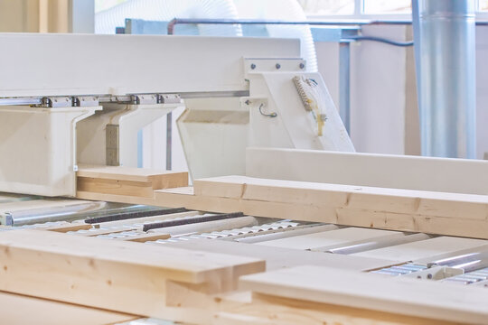 Glued Laminated Timber Lies On The Conveyor Belt Of A Woodworking Machine. Constructional Building Materials Made Of Wood. Woodworking Industry Concept.