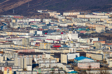 Fototapeta premium Aerial view of the city of Magadan. Top view of the streets, buildings and the cathedral. Large northern Russian city. Magadan, Magadan region, Siberia, Far East of Russia.