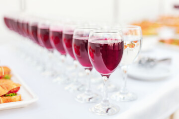 canapes and glasses with a red drink at the buffet