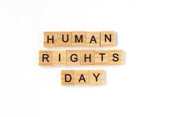 Top view of the word human rights day laid out from square wooden tiles on white background.