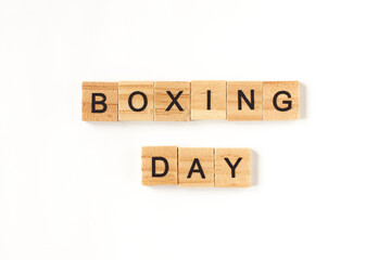 Top view of the words Boxing Day lined from square wooden tiles on white background. Photo for online online stores for the day of discounts during the holidays