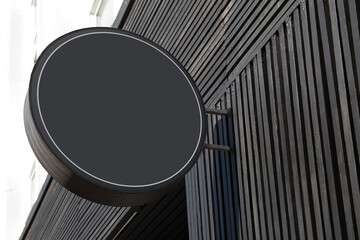 Round sign in black on the street, copy space