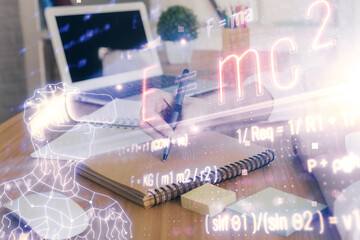 Science formula hologram over woman's hands taking notes background. Concept of study. Double exposure