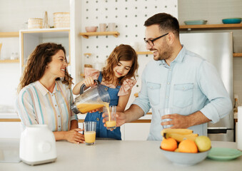 family child kitchen food daughter mother father orange juice healthy preparing drink  breakfast  together - Powered by Adobe