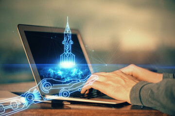 Start up drawings with businessman working on computer on background. Teamwork concept. Double...