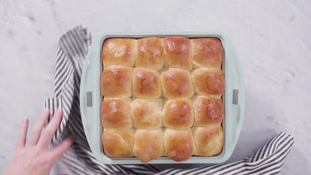 Flat lay. Preparing dinner rolls from the frozen dough in baking pan.