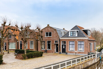 Fototapeta na wymiar Traditional residential buildings and canal in Hindeloopen, Netherlands, Europe