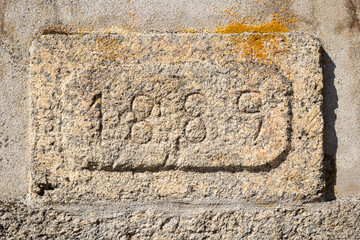 year 1889 carved in the stone