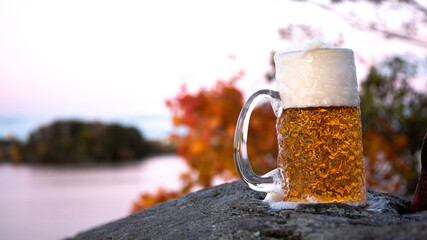 A cold lager beer sits on the rocks of the suburban archipelago in Stockholm, Sweden, on a cold and...