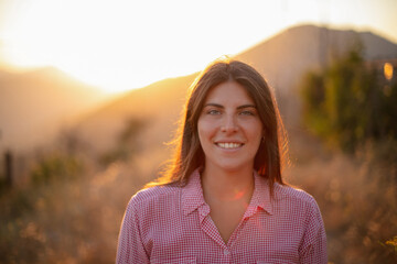 Portrait of a beautiful girl with sunset behind her back.