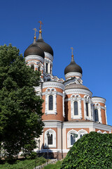 Fototapeta na wymiar Tallinn's Orthodox Alexander Nevsky Cathedral overlooks the trees in summer