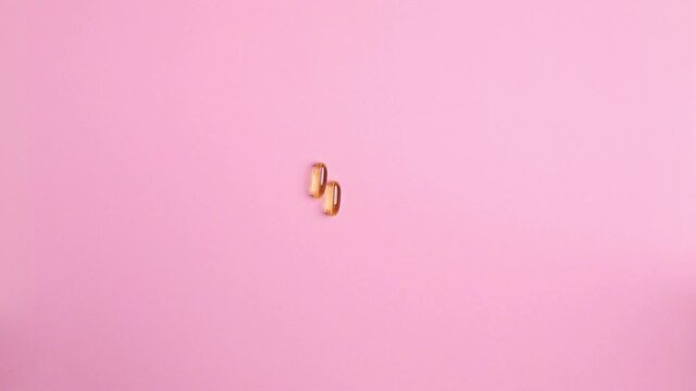 Omega vitamins 3 6 9 fish on pink background, vitamin for health view from adove
