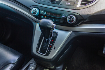 Obraz na płótnie Canvas automatic transmission shift selector in the car interior. Closeup a manual shift of modern car gear shifter.