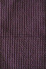 Textured purple linen waffle cotton towel. close up. Natural linen material violet towel pattern background.