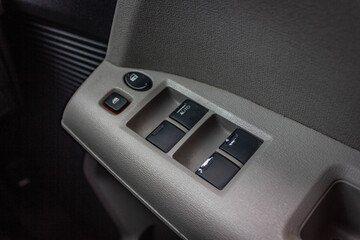 Car arm rest with Control Panel. Door Lock & Mirror Control. window adjustment buttons, door lock. Photography of a modern car.