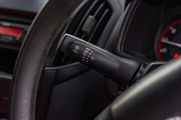 Obraz na płótnie Canvas Windscreen wiper control switch in car. Wipers control. Modern car interior detail. adjusting speed of screen wipers in car.