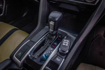 Plakat automatic transmission shift selector in the car interior. Closeup a manual shift of modern car gear shifter.