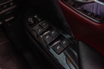 Obraz na płótnie Canvas Car arm rest with Control Panel. Door Lock & Mirror Control. window adjustment buttons, door lock. Photography of a modern car.