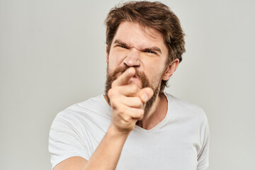 Fototapeta premium man in white t-shirt emotions expressions gesture with hands cropped view light background