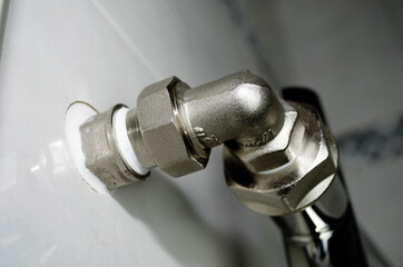 Heating pipes in the bathroom. Towel radiator close-up