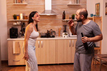 Young couple with serious social issues and wife suffering of cruel injuries. Violent aggressive...
