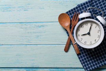 Food clock, healthy food time concept on blue table background