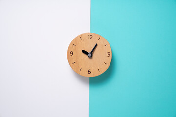 Fototapeta na wymiar Retro alarm clock on green and white table background, vintage style