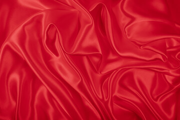 Beautiful elegant wavy hot red satin silk luxury cloth fabric texture, abstract background design. Wallpaper, banner or card