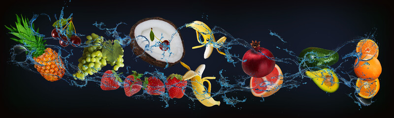 Panorama with fresh fruits in the water - pineapple, cherries, grapes, strawberries, banana, pomegranate, grapefruit, avocado, orange, a very tasty dessert for Halloween, Christmas and New Year