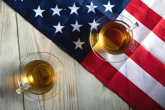 concept of ideological duel in US presidential election. Two glasses opposite each other on background of American flag - Powered by Adobe