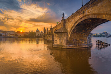 Charles bridge over the Vltava river in Prague at sunrise