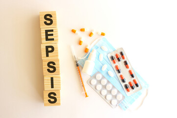 The word SEPSIS is made of wooden cubes on a white background. Medical concept.