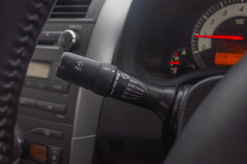 Windscreen wiper control switch in car. Wipers control. Modern car interior detail. adjusting speed of screen wipers in car.