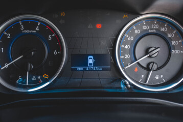 Car​ dashboard​ modern​ automobile control​ illuminated panel​ speed display.