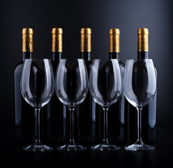 wine bottles and glass with black background