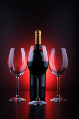 wine bottles and full glass with red and black background