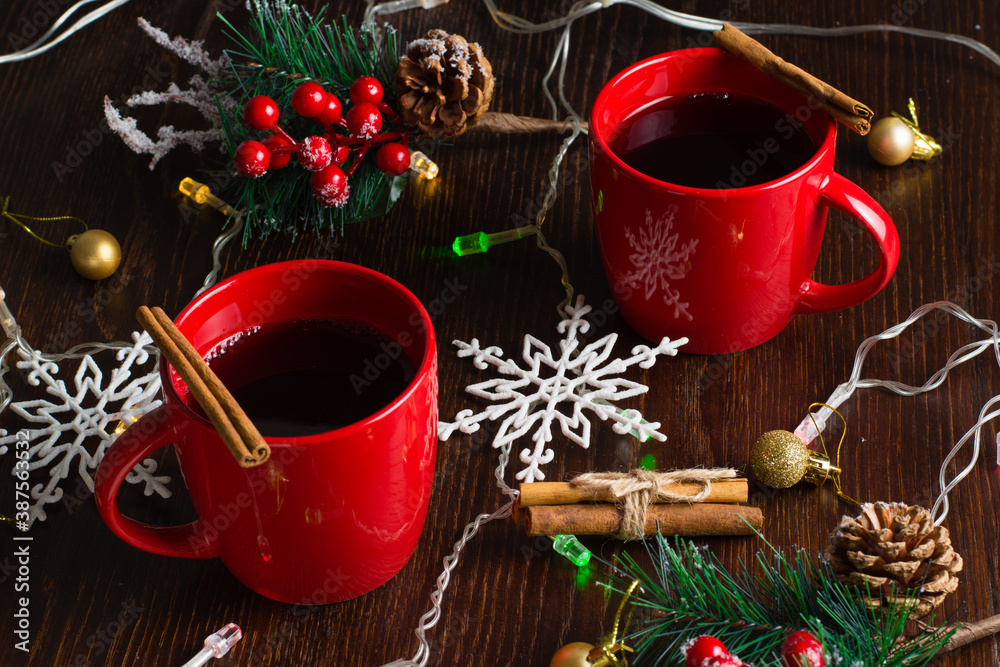 Wall mural cinnamon mulled wine in two red cups. waiting for christmas, view from the top